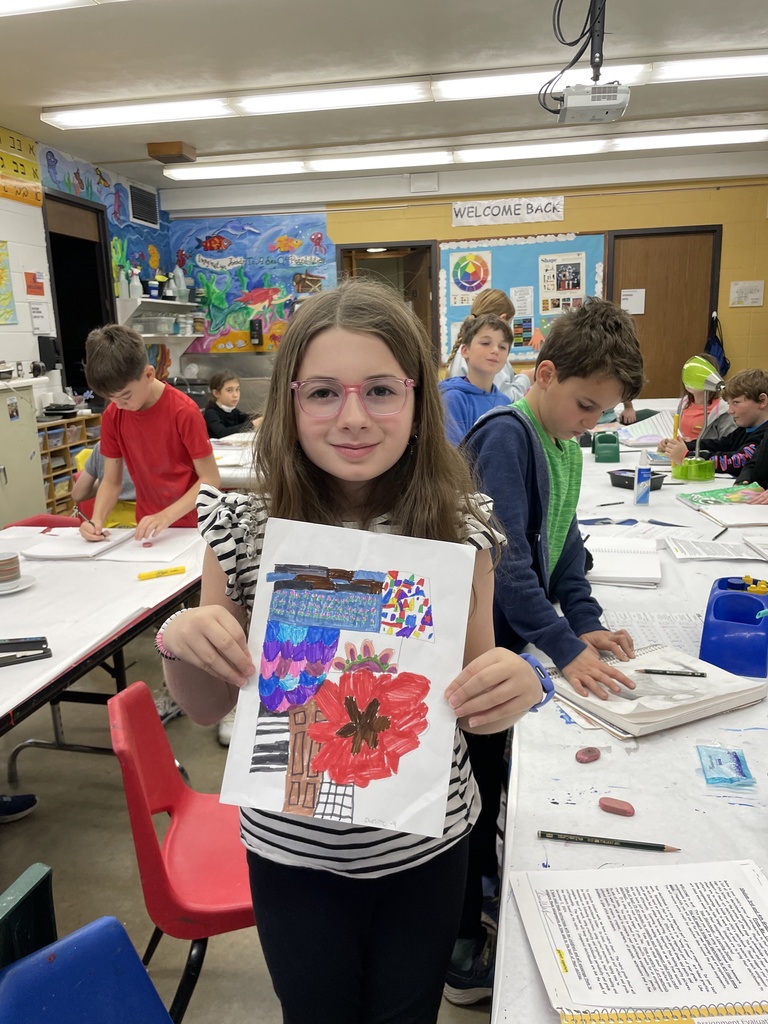 student shows sketchbook