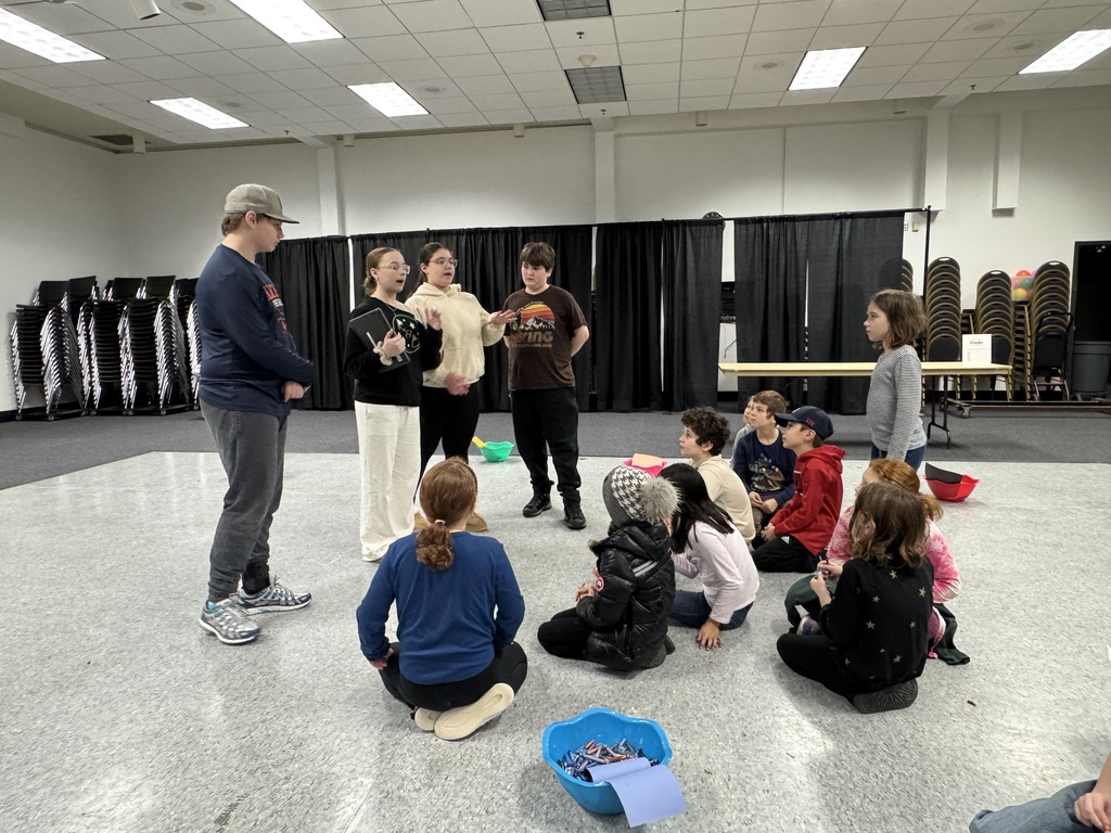 eighth graders give instructions to younger students