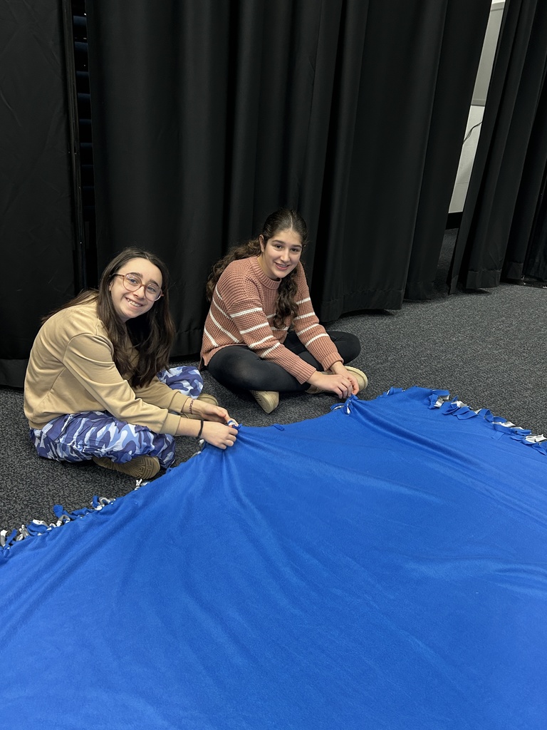 students tie blankets