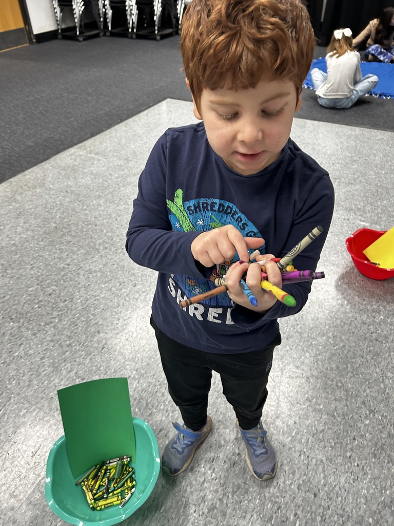 student sorts crayons