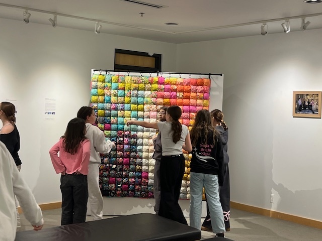 students look at poof blanket