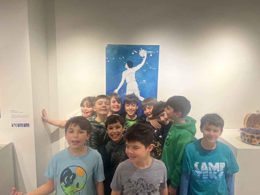 boys pose in front of basketball art