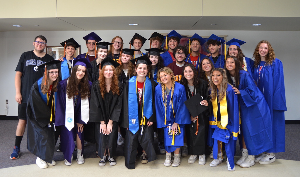high school seniors who attended Heilicher pose in their caps and gowns