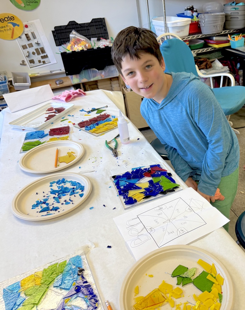 student poses with glass drip plate