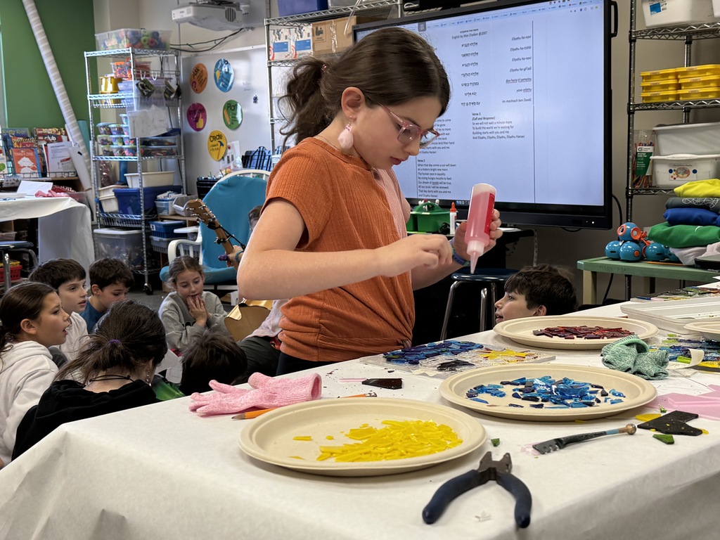 student glues glass pieces