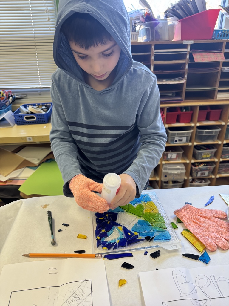 student glues glass pieces