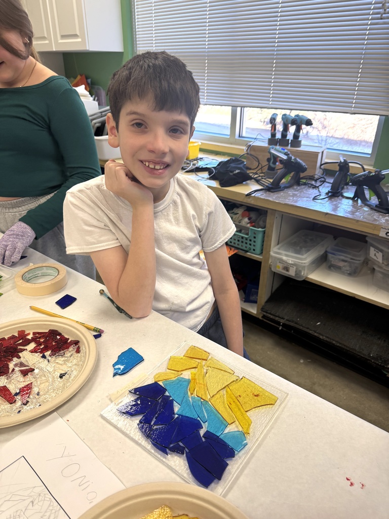 student poses with glass drip plate