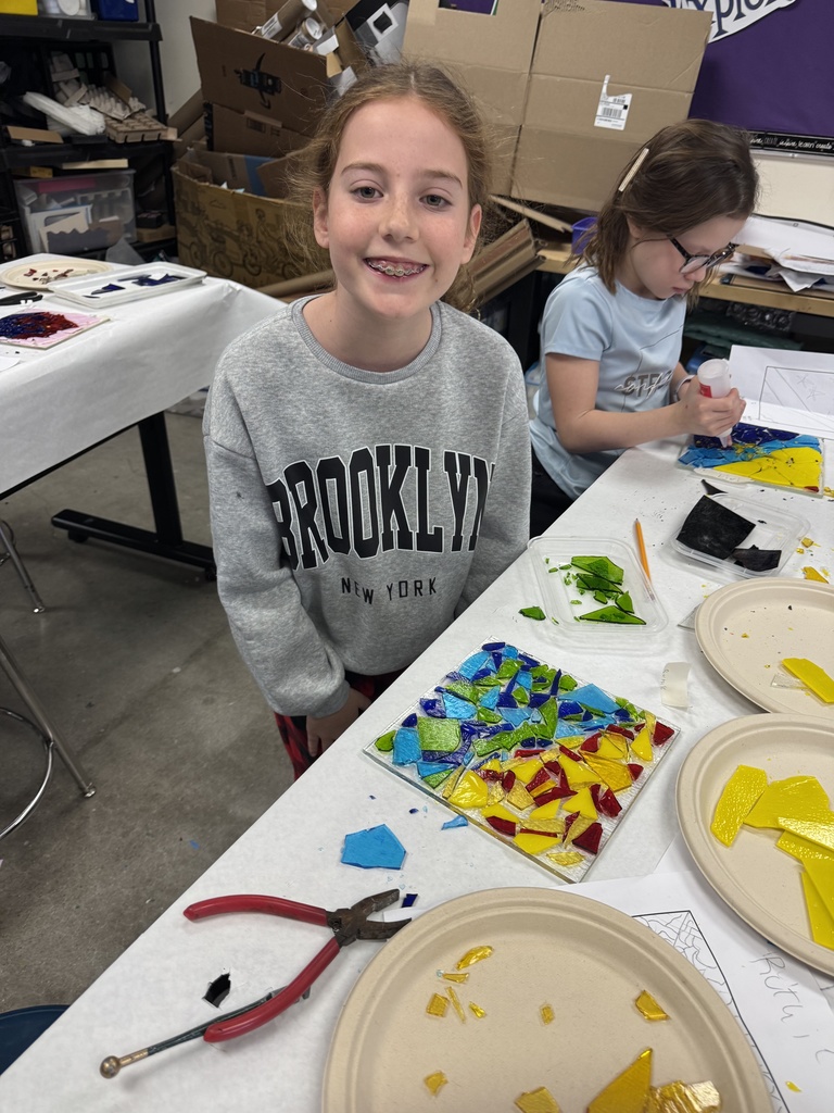 student poses with glass drip plate