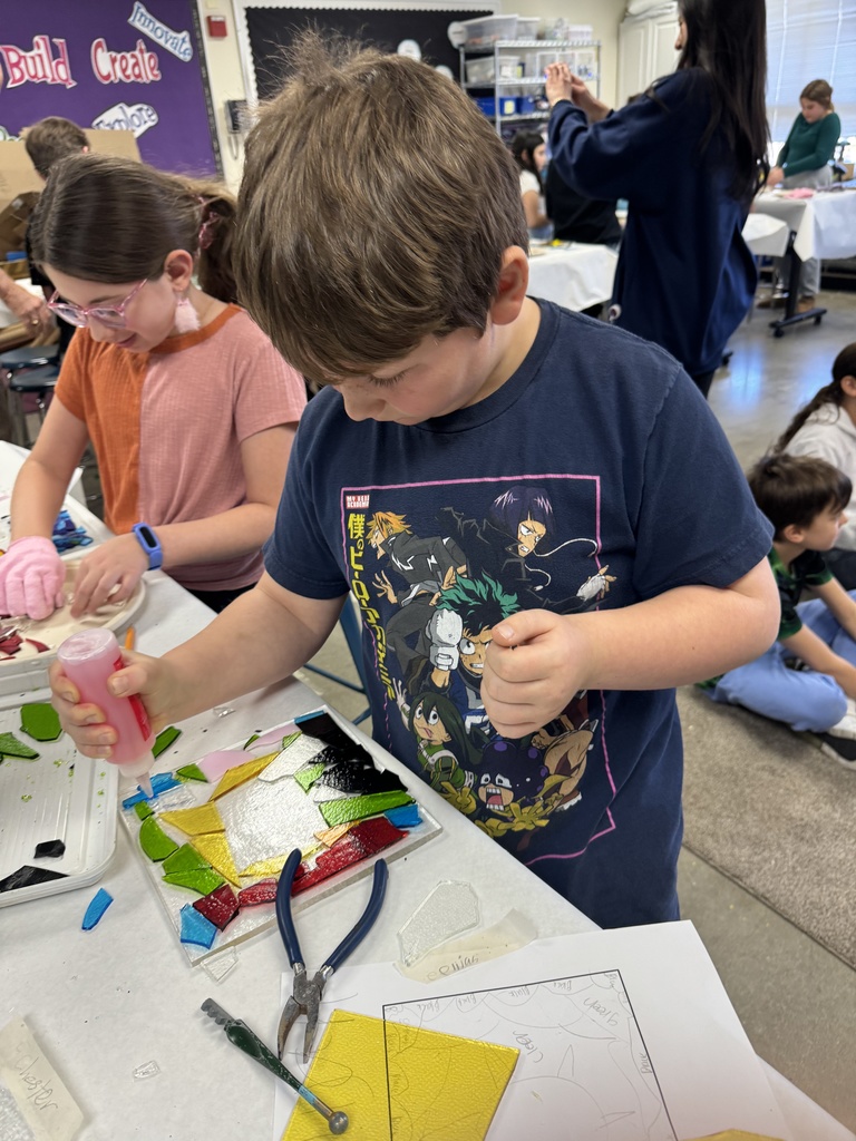 student glues glass pieces