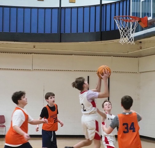 opposing basketball player takes layup