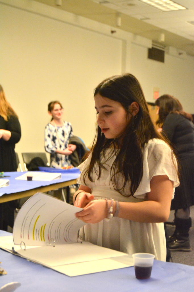 student turns page in binder