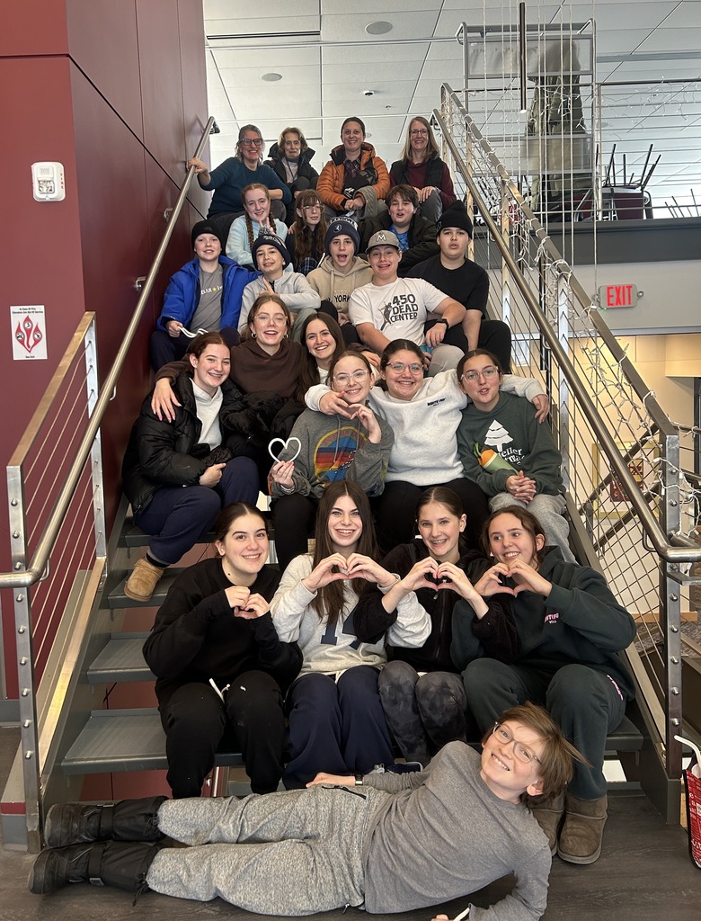 eighth graders sit on stairs at Hillel for picture
