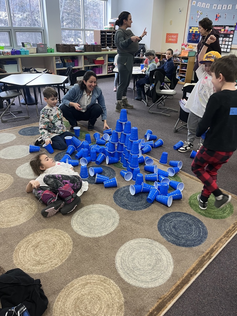 students celebrate cup tower falling