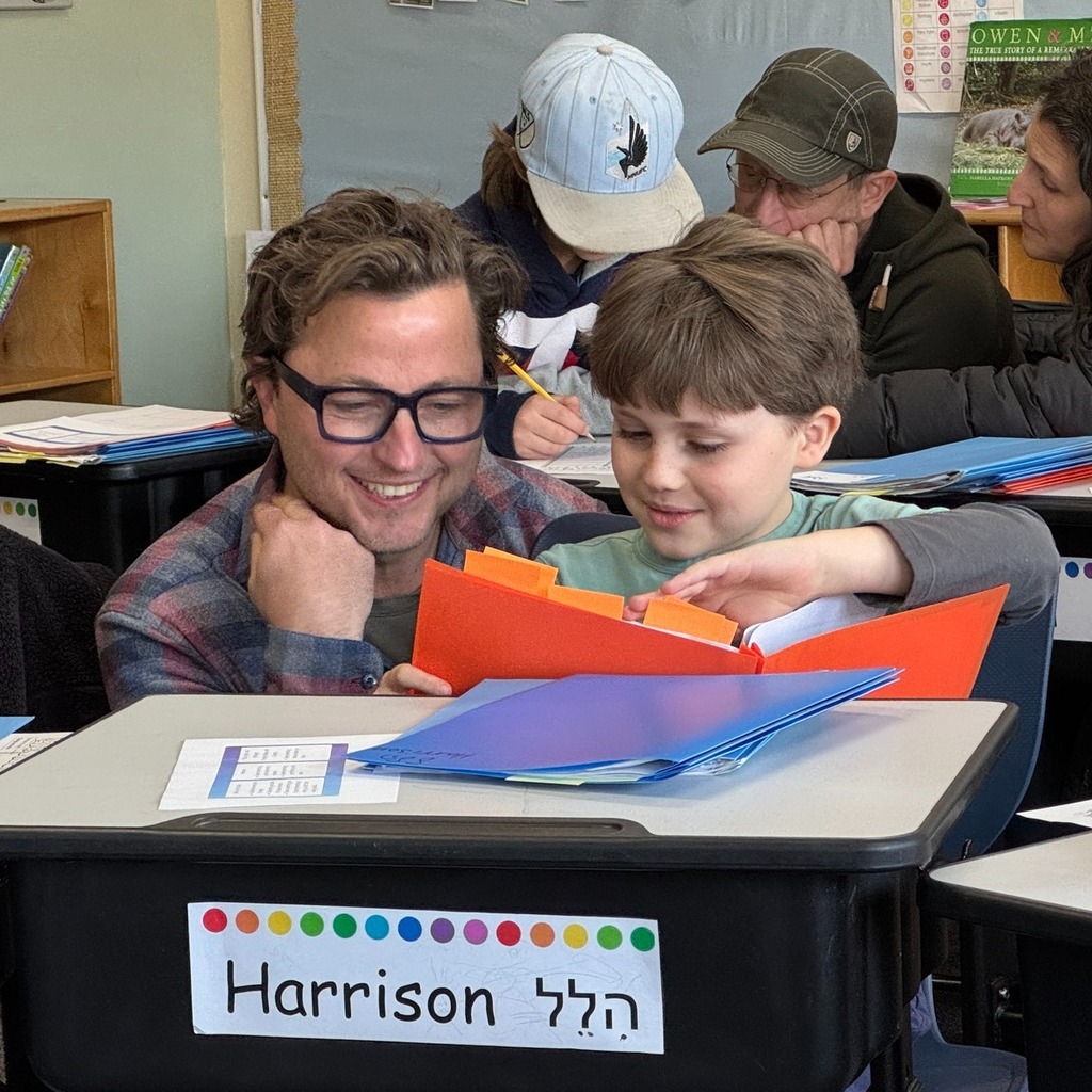 student shows work to guest