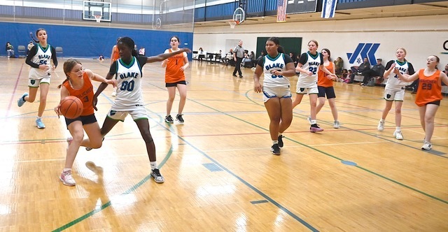 basketball player dribbles through defense