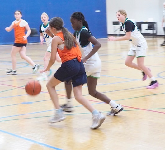 basketball player dribbles down court