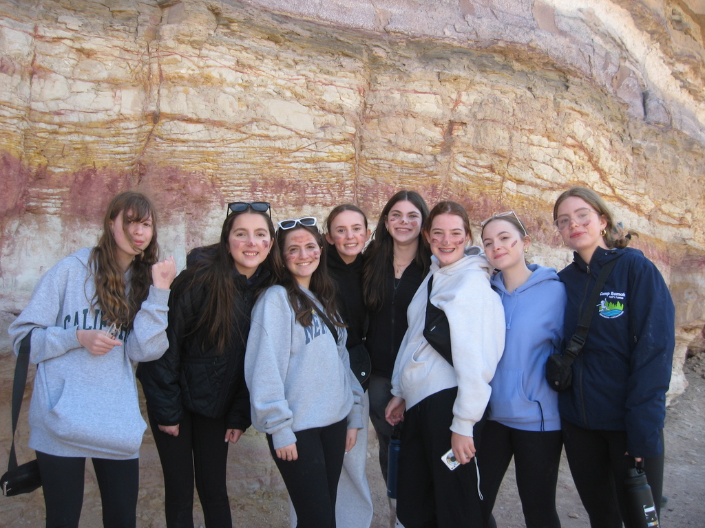 students in front of colorful cliff face