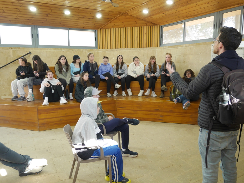students listen to tour guide