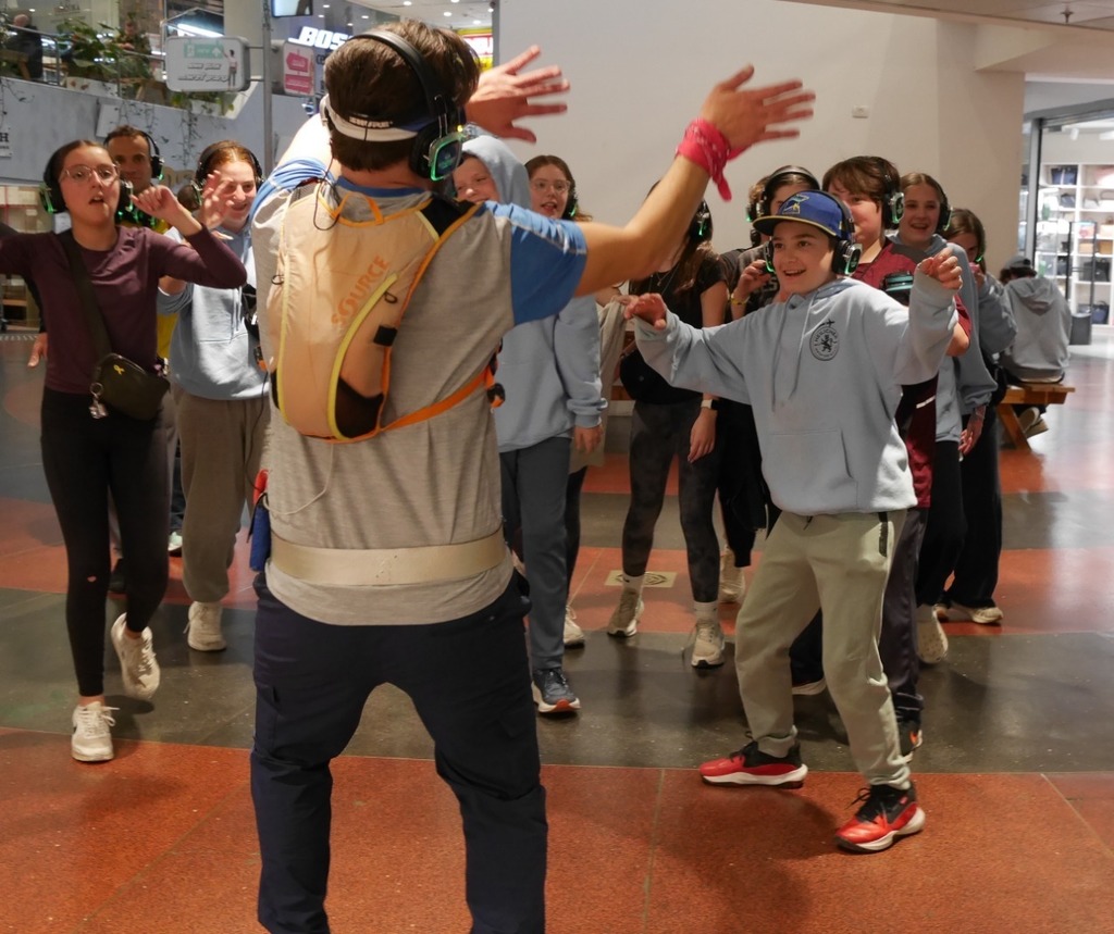 Aliyah Chet wearing headphones dances in mall