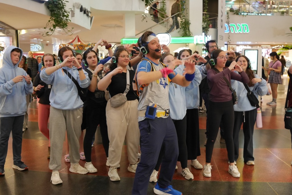 Aliyah Chet wearing headphones dances in mall