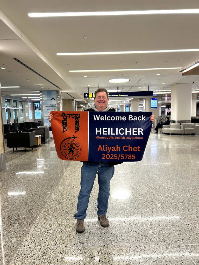Dr. Dan holds welcome back banner