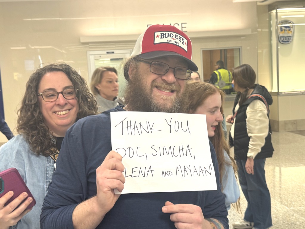parent holds thank you sign for faculty chaperones