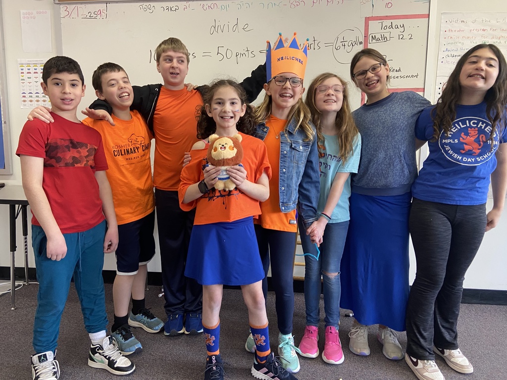 fifth graders in orange and blue