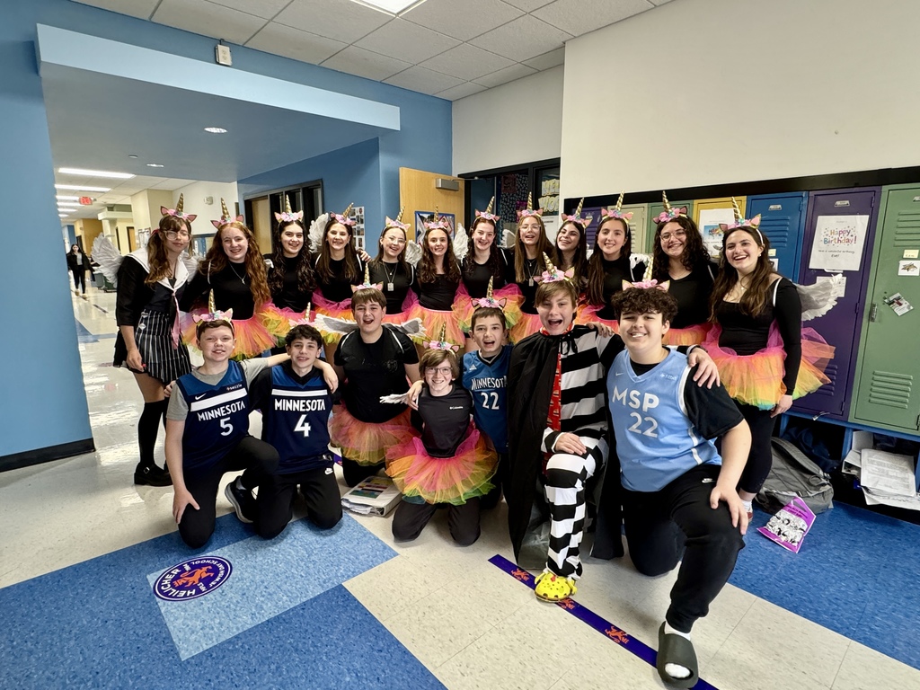 eighth graders dressed as rainbow unicorns
