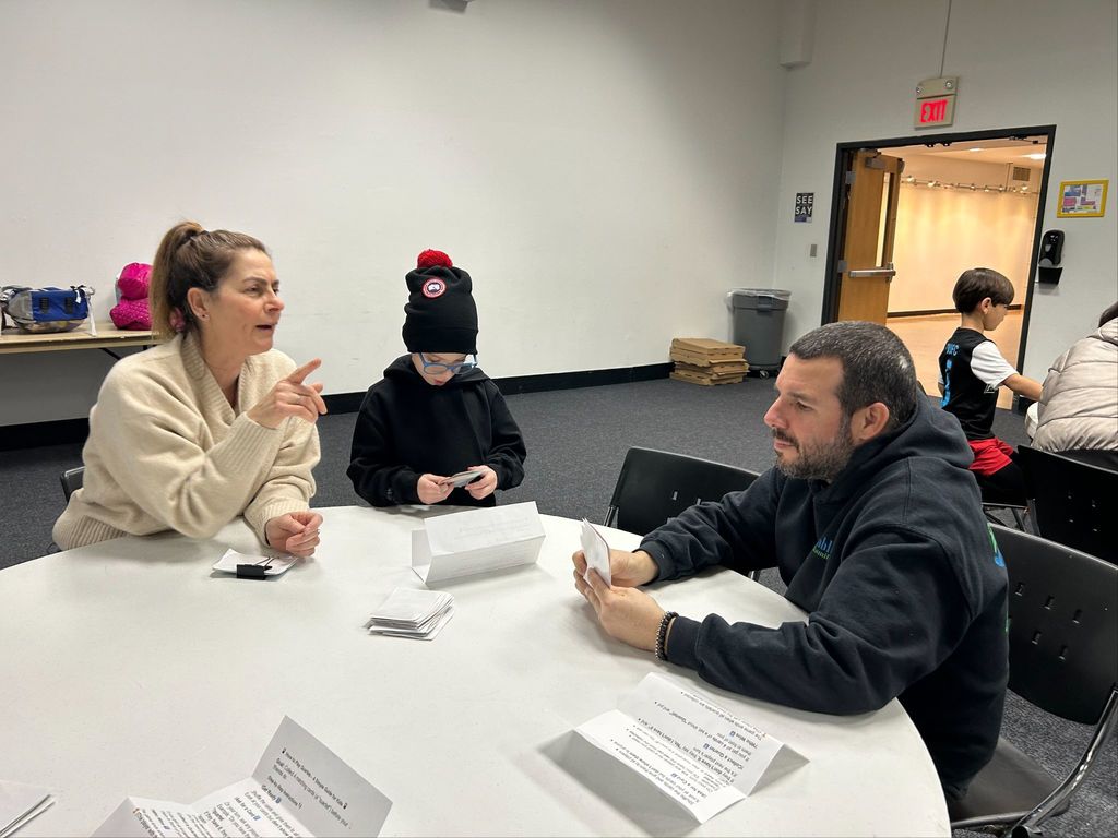 teacher talks with father and son