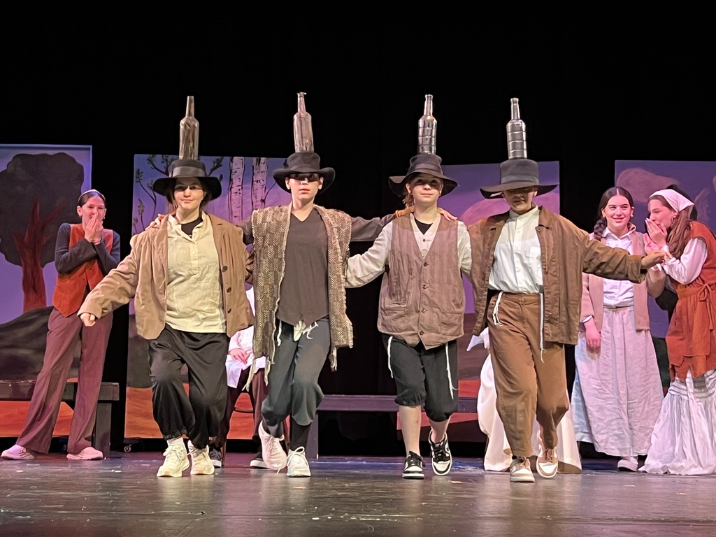 dancers balance bottles on their heads