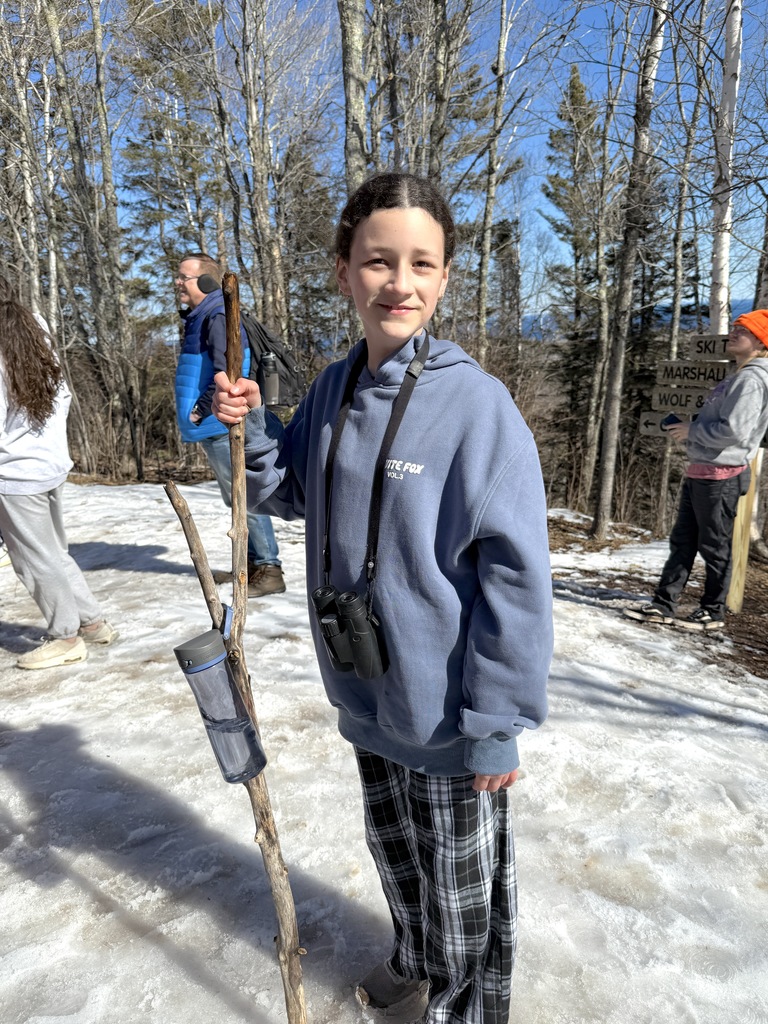 student with hiking stick