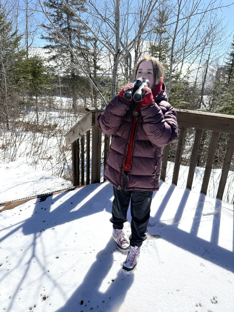 student uses binoculars
