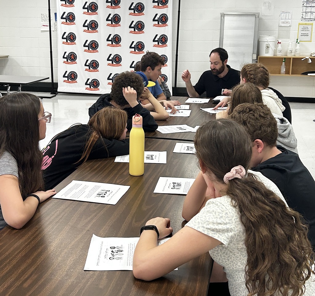 rabbi leads small group discussion with middle schoolers