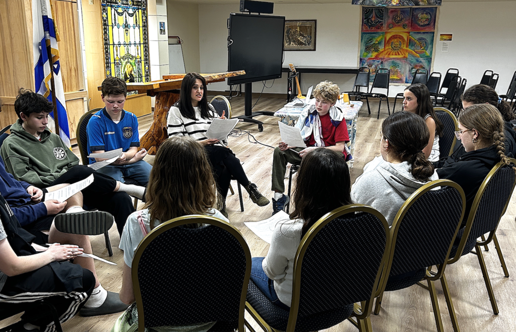 rabbi leads small group discussion with middle schoolers