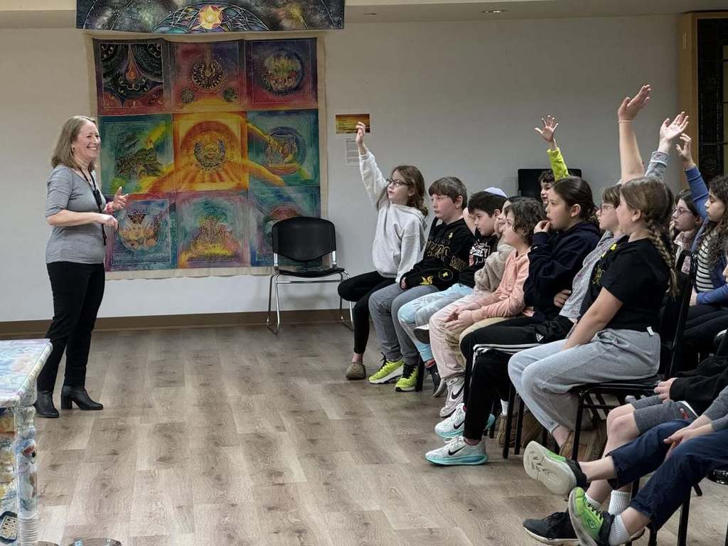 students raise hands