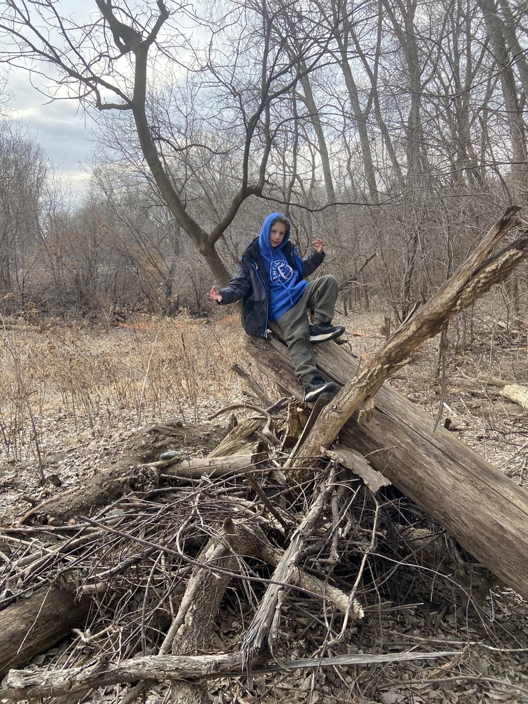 student sits on log