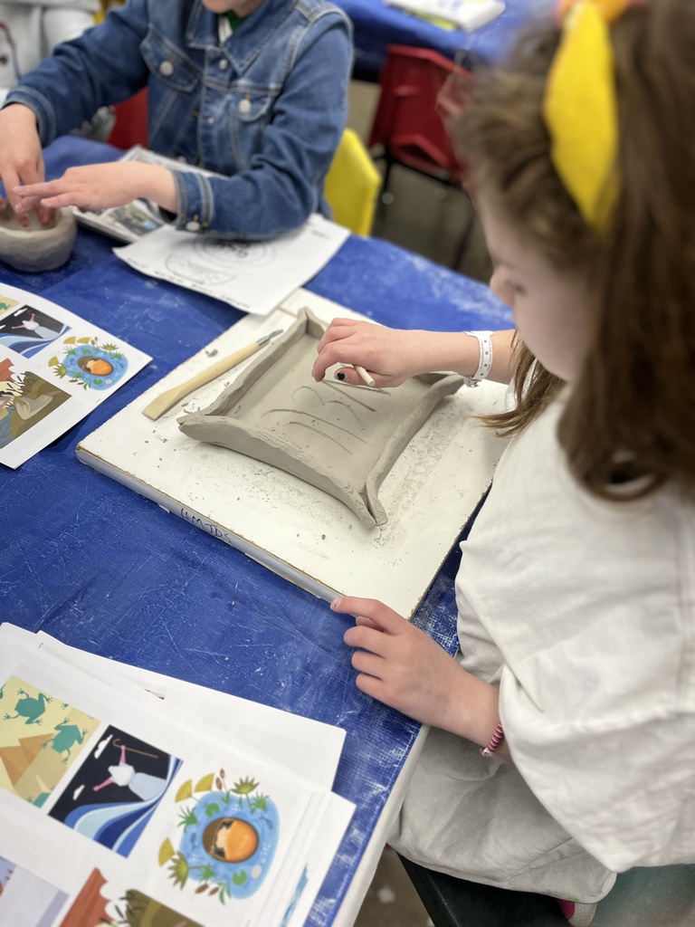student etches design into clay
