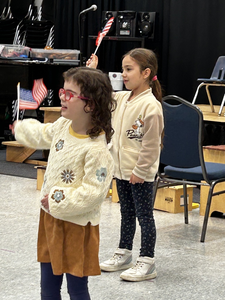 kindergartners wave American flags