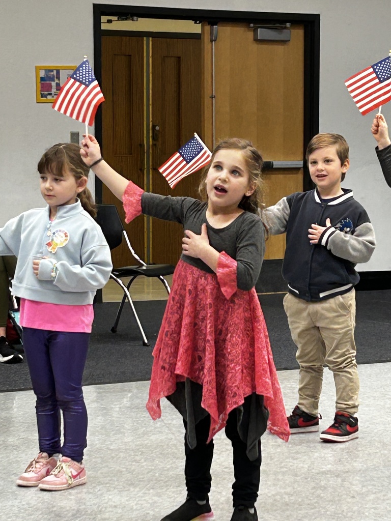kindergartners wave American flags