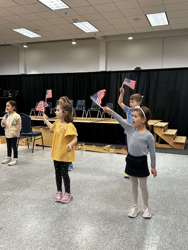 kindergartners wave American flags