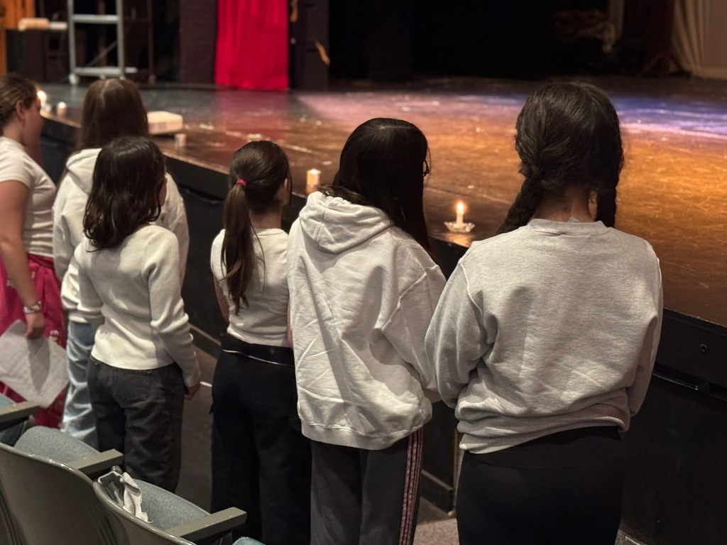 students stand in silence