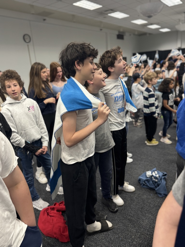 middle schools boys drape Israeli flag blanket around themselves