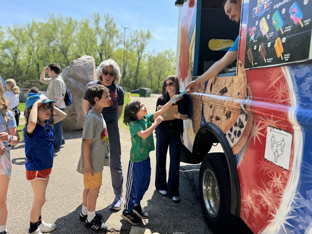 students get ice cream from ice cream truck