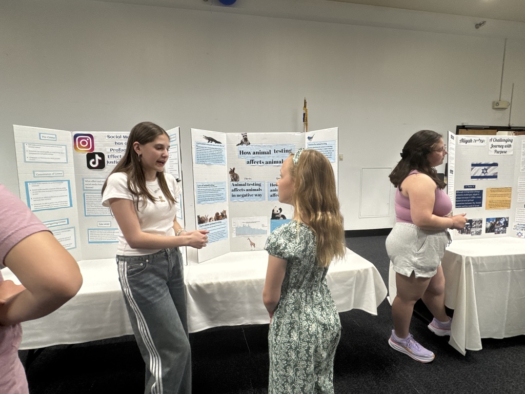 eighth grader presents to younger student