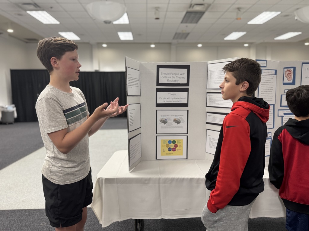 eighth grader presents to younger student