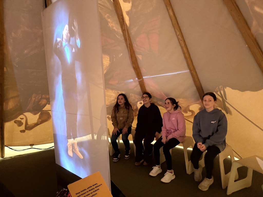 students watch video in tipi