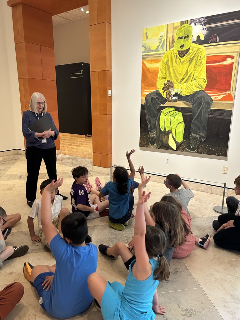 students raise hands as docent tells about painting