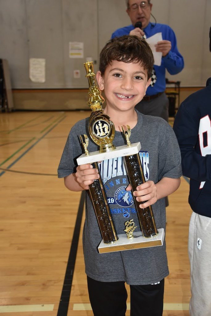student with chess trophy
