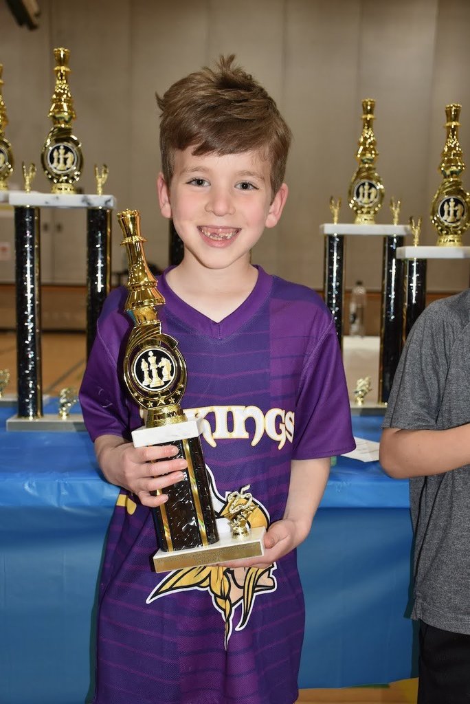 student with chess trophy