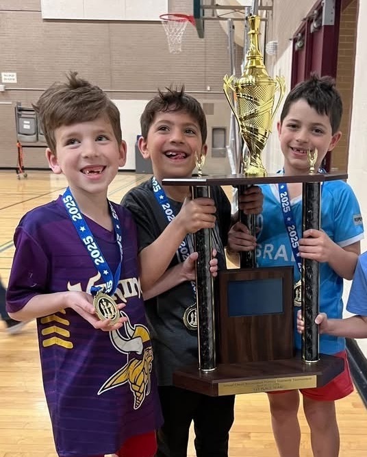 students with chess trophy